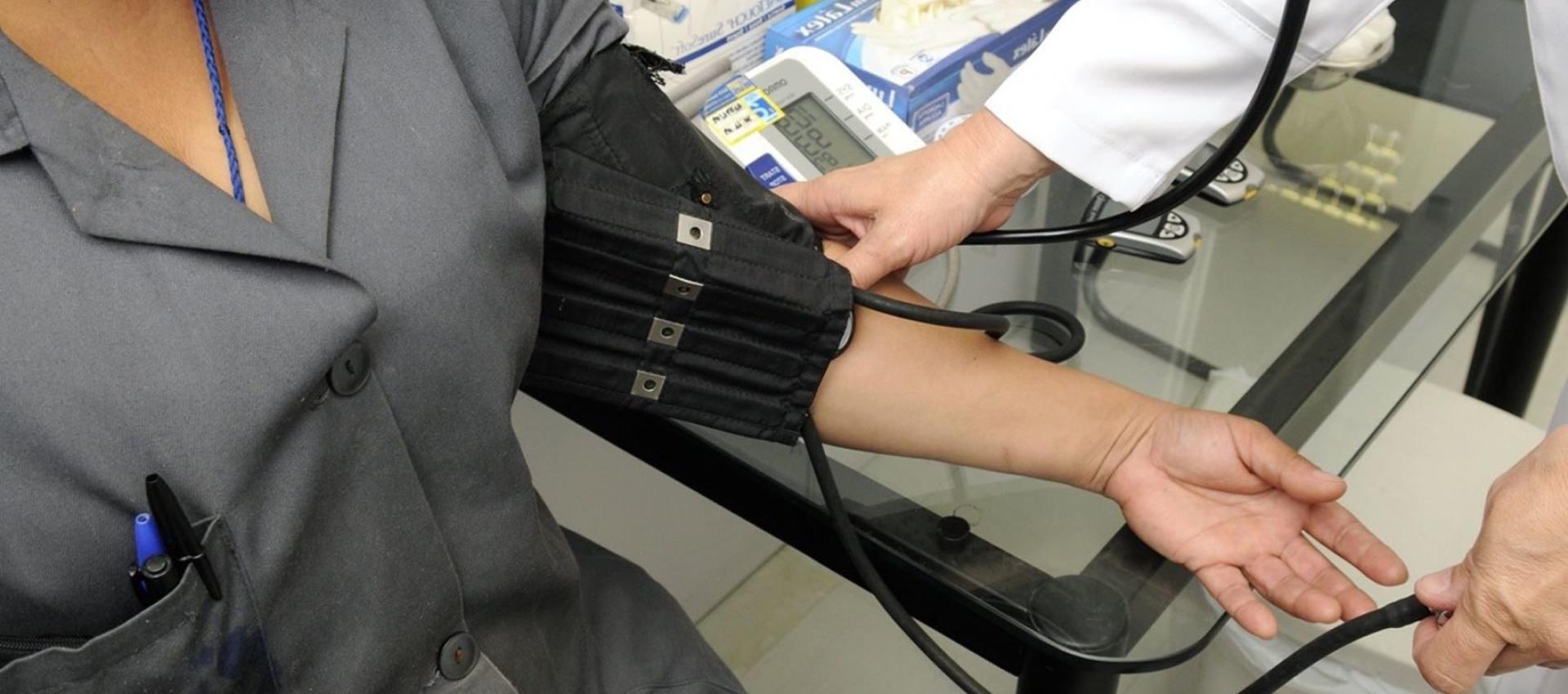 Doctor taking patient's blood pressure